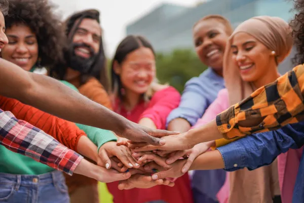 crowd-of-multiracial-people-stacking-hands-outdoor-2026-01-09-10-35-06-utc-697b56ed4e3cf